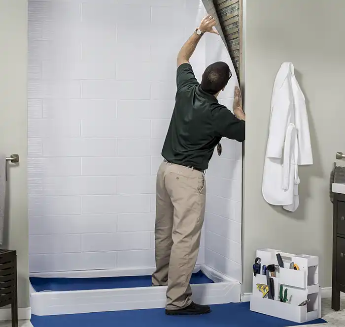 man replacing shower liner.